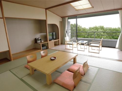 a living room with a table and chairs and a balcony at Villa Inawashiro - Vacation STAY 27680v in Inawashiro