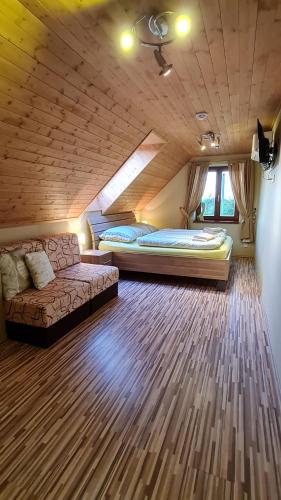 a large room with two beds and a couch at Vinárstvo u Kohúta in Skalica