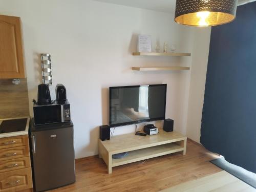 a living room with a flat screen tv on a table at Apartmány Liptov MACO in Liptovský Mikuláš