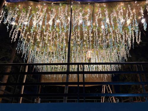 a chandelier of lights hanging from a ceiling at Niladri farms in Bhundsi