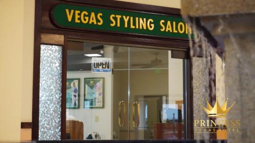 a sign for a versas styling salon in a store at Princess Vegas Hotel & Casino in Corozal