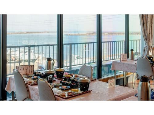 a dining room with a table and a view of the ocean at Kaifutei Teradomari Nihonkai - Vacation STAY 25854v in Nagaoka