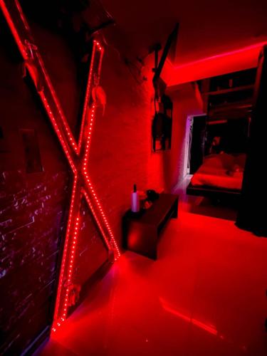 a red room with a bed and a red light at Cap Red Room in Cap d'Agde