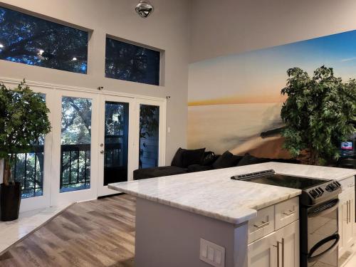 a kitchen with a counter top in a living room at The Duke's Castle with Garage & Fast Internet in Dallas
