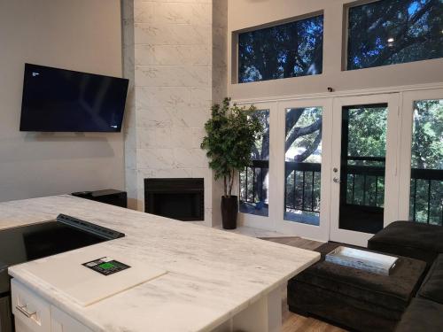 a living room with a table and a fireplace at The Duke's Castle with Garage & Fast Internet in Dallas