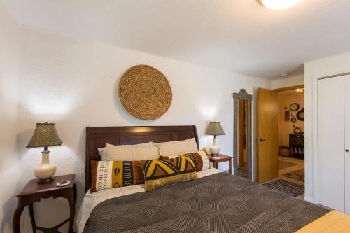 a bedroom with a large bed and two lamps at SQ Ramblin Rose 3 in Sequim