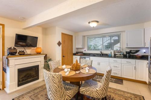 a kitchen with a table and chairs and a fireplace at SQ Ramblin Rose 3 in Sequim