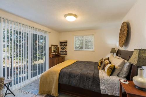 a bedroom with a bed and a large window at SQ Ramblin Rose 3 in Sequim