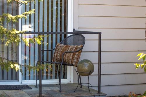 a bench with a pillow and a ball next to a door at SQ Ramblin Rose 3 in Sequim