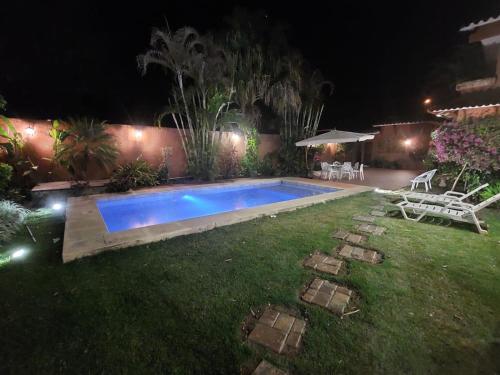 a swimming pool in a yard at night at LA CASONA Hotel Boutique in Refineria Camiri