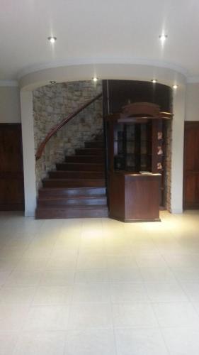 a hallway with a staircase in a building at LA CASONA Hotel Boutique in Refineria Camiri