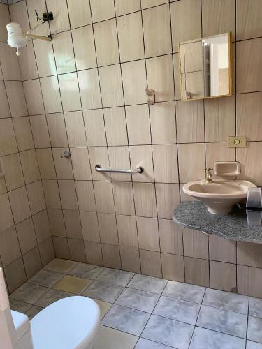 a bathroom with a toilet and a sink at Casa do Marcus in Barra do Garças