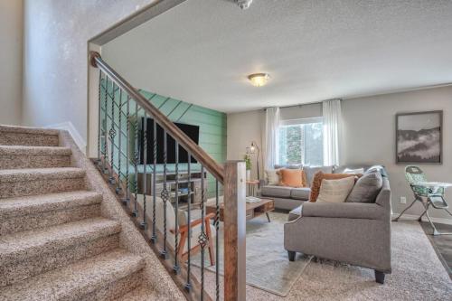 a living room with a staircase and a couch at Lindenmere Horizon Game Loft Fire Pit & WiFi in Monument