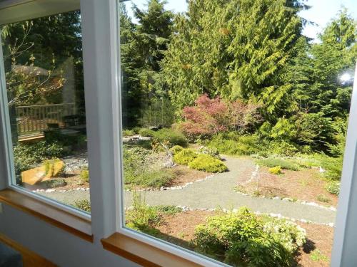 a view of a garden from a window at PA Whispering-Pines in Port Angeles