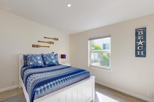 a white bedroom with a bed and a window at Lime in the Coconut in Marathon