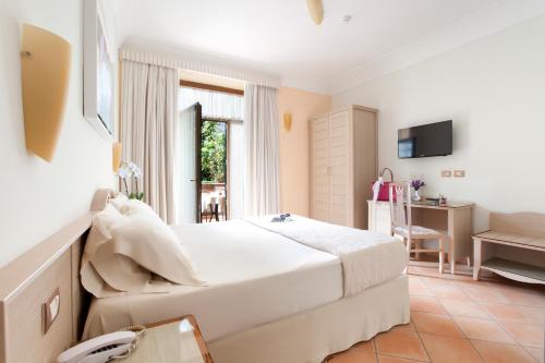 Säng eller sängar i ett rum på Relais Villa Angiolina