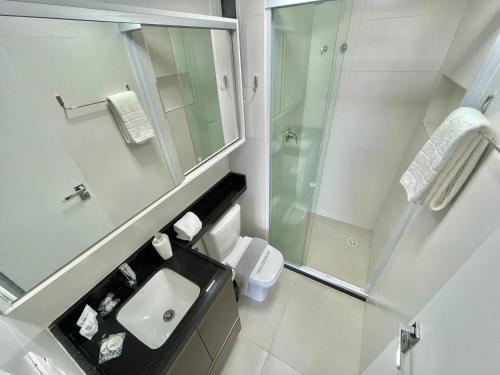 a bathroom with a toilet and a sink and a shower at RN Studio Premium Max Rev in Maceió