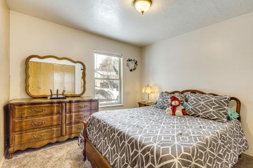 a bedroom with a bed with a dresser and a mirror at Fenced Yard, Patio Family-Friendly Pocatello Home in Pocatello