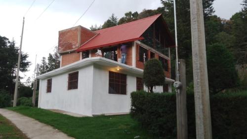 a house with a red roof on top of it at Cabaña Cedros Mineral del Chico in Mineral del Chico