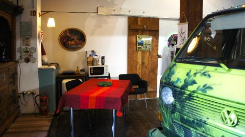 a room with a table and a green van at Urban Van Glamping Riga in Rīga