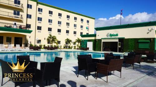 a hotel with a swimming pool in front of a building at Princess Vegas Hotel & Casino in Corozal