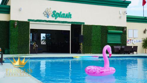 a pink swan in a pool in front of a building at Princess Vegas Hotel & Casino in Corozal
