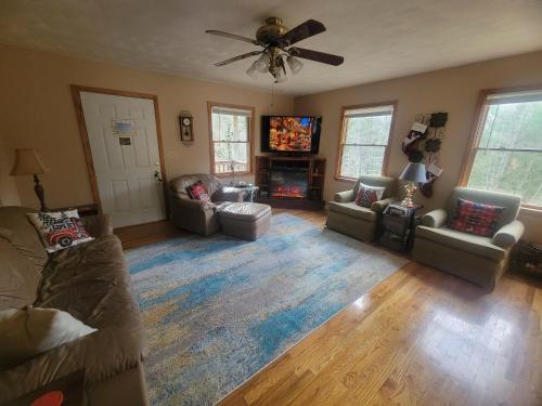 un soggiorno con divani e TV a schermo piatto di Carrie's Cottage a Rogers