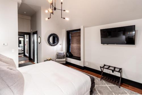 a bedroom with a white bed and a chandelier at The Firehouse in Newport