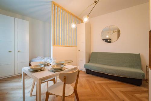 - un salon avec une table et un lit vert dans l'établissement Rocky #cathedraledereims, à Reims