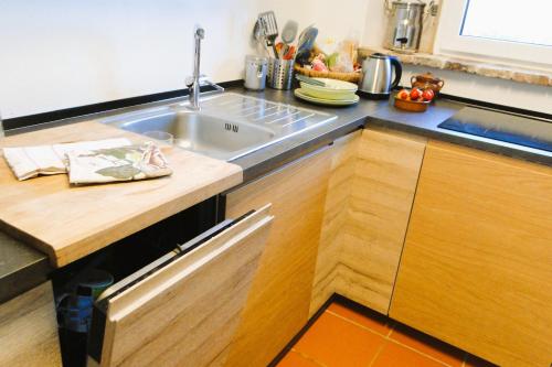 a kitchen with a sink and a wooden counter top at Villa Ceppeto, Best Of Tuscany at Brand New Nest in Monte San Savino