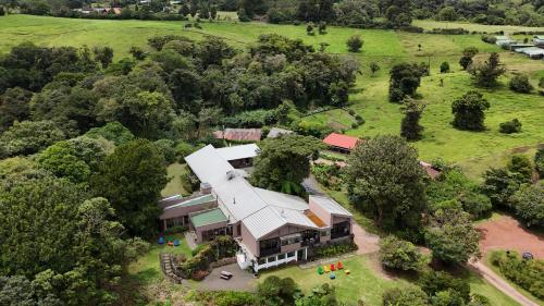 an aerial view of a large house with a white roof at Poas Volcano Lodge in Vara Blanca