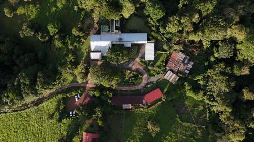 an aerial view of a house in the forest at Poas Volcano Lodge in Vara Blanca