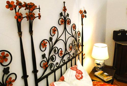 a bedroom with a bed with a flower patterned headboard at Villa Ceppeto, Best Of Tuscany at Brand New Nest in Monte San Savino