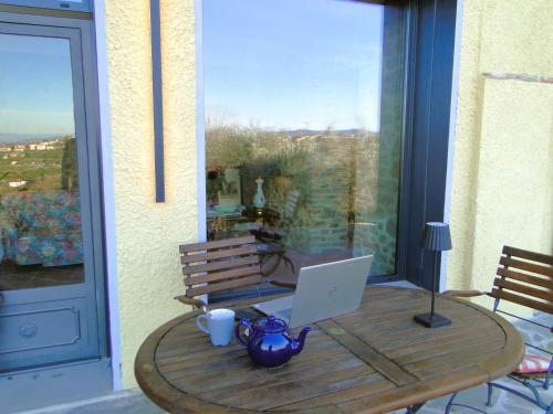 a wooden table with a laptop on top of it at Villa Ceppeto, Best Of Tuscany at Brand New Nest in Monte San Savino