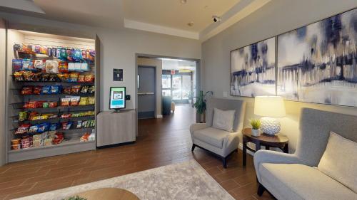 a waiting area of a store with a couch and chairs at Comfort Inn Gaslamp Convention Center in San Diego