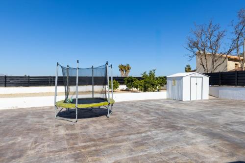 a metal swing sitting on top of a roof at Palm Breeze Villa by Fidalsa in Catral