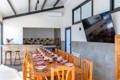 a dining room with a long wooden table with chairs at Palm Breeze Villa by Fidalsa in Catral