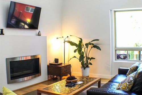 a living room with a couch and a tv at Sqe Mystic Grove in Sequim