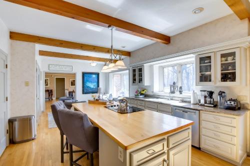 a kitchen with a large island in the middle at Spacious and Secluded Madison Home Near Dtwn! in Madison