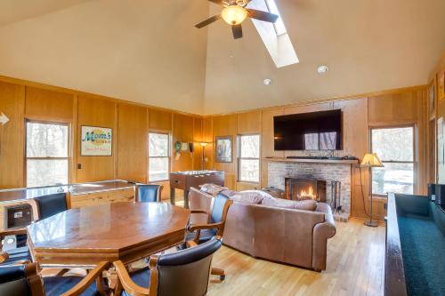 a living room with a table and a fireplace at Spacious and Secluded Madison Home Near Dtwn! in Madison