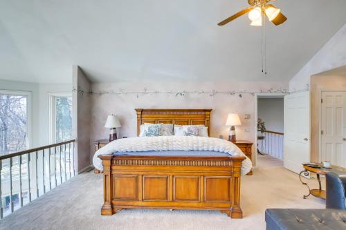 a bedroom with a wooden bed and a balcony at Spacious and Secluded Madison Home Near Dtwn! in Madison