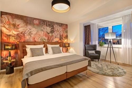 a bedroom with a large bed and a floral wall at Blumen(t)raum Ferienwohnung 2 in Karlsruhe