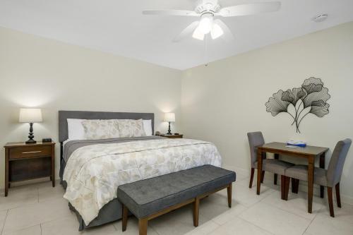a bedroom with a bed and a table and chairs at The Fairways Inn of Naples in Naples