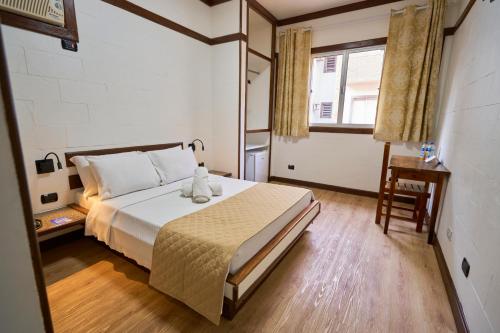 a bedroom with a bed and a chair and a window at SESC CONTAGEM in Contagem