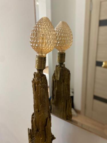 a lamp made out of drift wood with a mirror at Golden Rush in Rīga