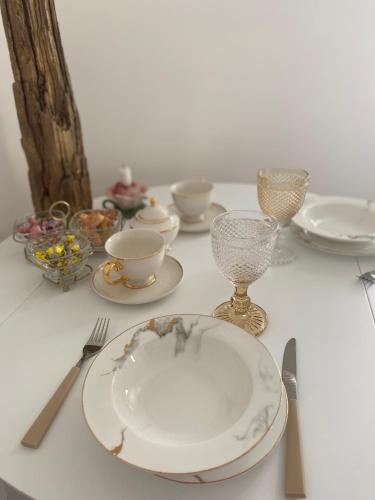 a table with an empty plate and glasses and utensils at Golden Rush in Rīga
