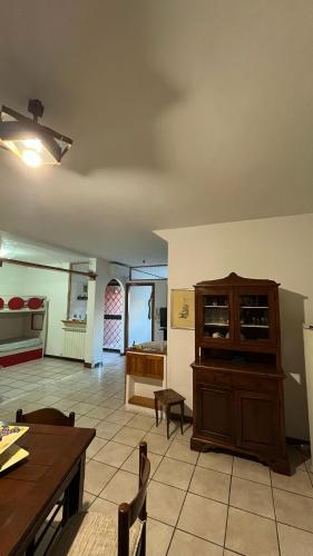 a living room with a wooden cabinet and a table at La Dimora Di Ale in Monterosi