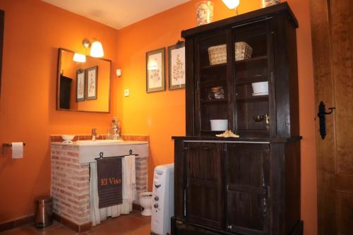 ein Badezimmer mit Waschbecken und Holzschrank in der Unterkunft Finca Rural con piscina en Calera y Chozas in Talavera de la Reina