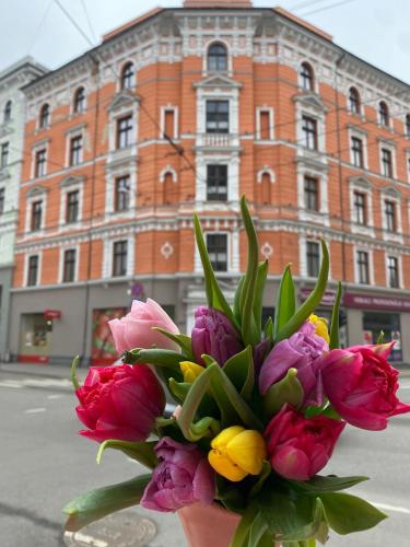 a bouquet of flowers in front of a building at Golden Rush in Rīga