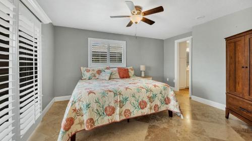 a bedroom with a bed and a ceiling fan at NPL829 in Punta Gorda